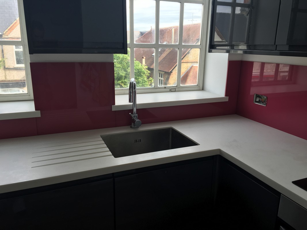 Deep plum coloured glass splashback in modern Archway kitchen