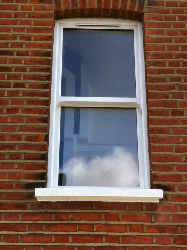 uPVC sash window on Victorian red brick house in Archway